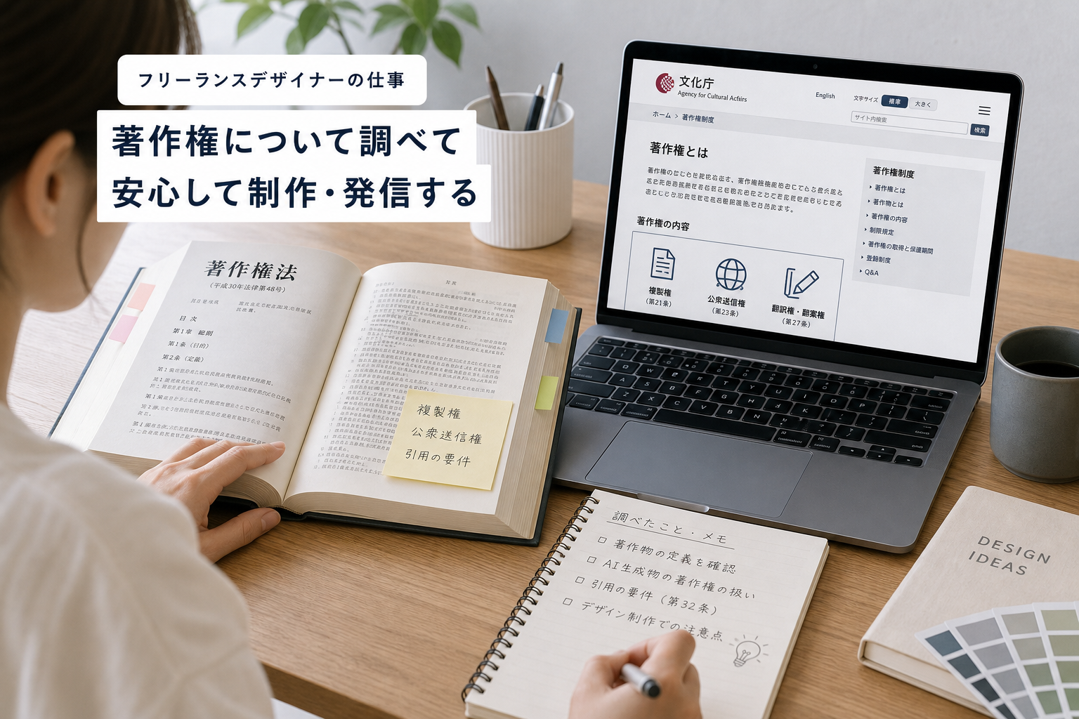 法律書とノートパソコンを開いて著作権について調べているフリーランスデザイナーの作業デスク